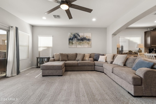 carpeted living room featuring ceiling fan