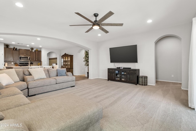 living room with ceiling fan and light carpet