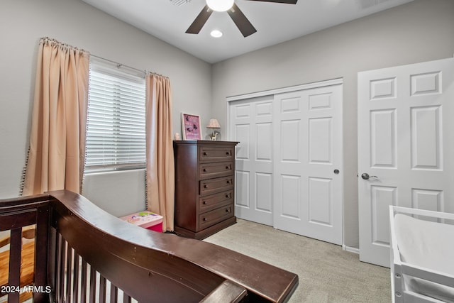 carpeted bedroom with a closet and ceiling fan