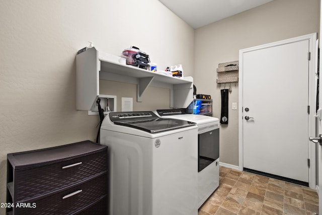 clothes washing area featuring washer and clothes dryer