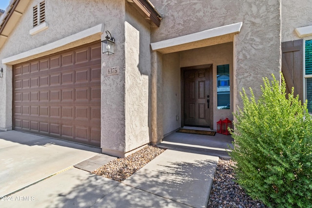 doorway to property with a garage