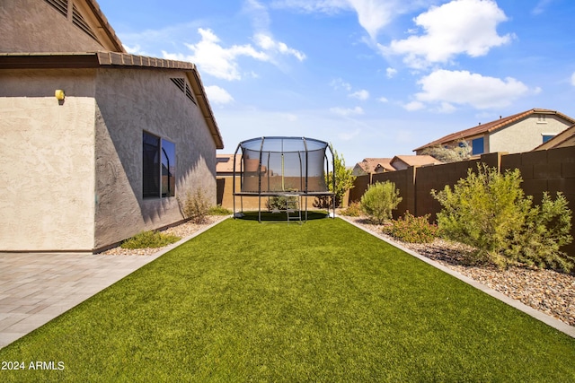 view of yard featuring a patio area and a trampoline