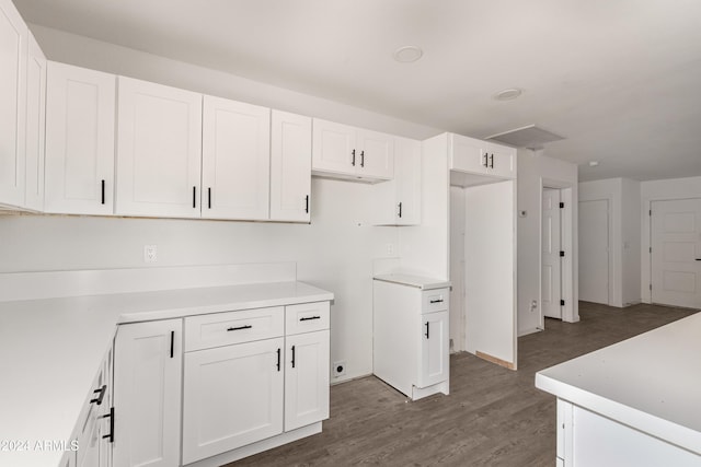 kitchen featuring white cabinets and dark wood-type flooring