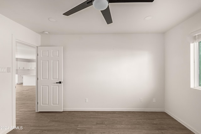 spare room with ceiling fan and dark hardwood / wood-style flooring