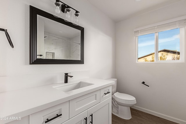 bathroom with vanity, toilet, wood-type flooring, and walk in shower