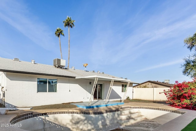 rear view of house with a patio area and central AC