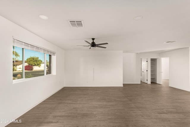 unfurnished room with ceiling fan and dark wood-type flooring