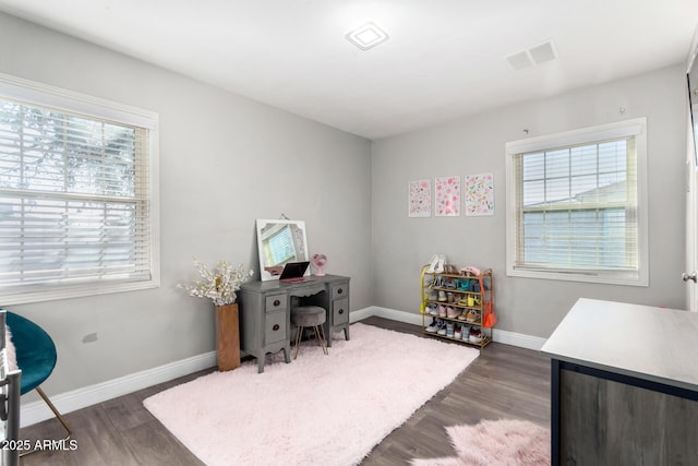 home office with dark hardwood / wood-style flooring