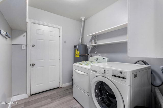 laundry room with washer and clothes dryer, gas water heater, and light hardwood / wood-style flooring