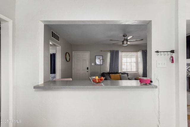 kitchen featuring ceiling fan and kitchen peninsula