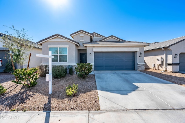 single story home featuring stucco siding, an attached garage, driveway, and a tiled roof