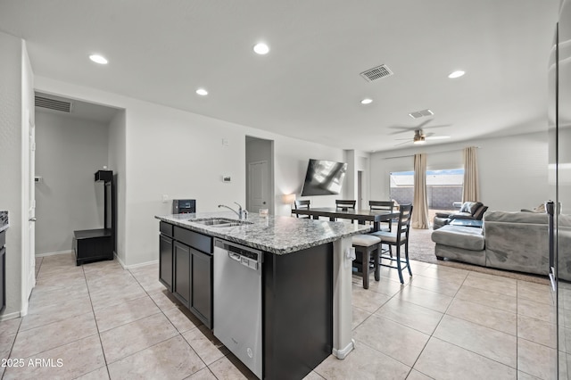 kitchen with stainless steel dishwasher, light tile patterned floors, visible vents, and a sink