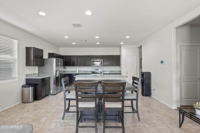 dining area with light tile patterned flooring, visible vents, recessed lighting, and baseboards