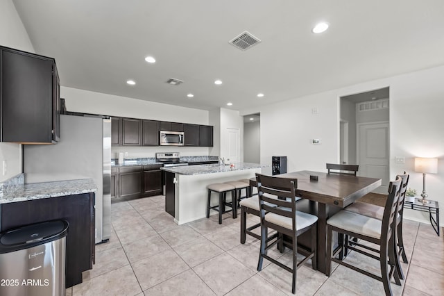 dining space featuring light tile patterned flooring, recessed lighting, and visible vents