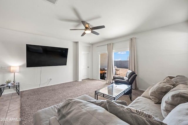 carpeted living room featuring visible vents, baseboards, and ceiling fan