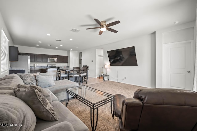 living area with recessed lighting, visible vents, and a ceiling fan