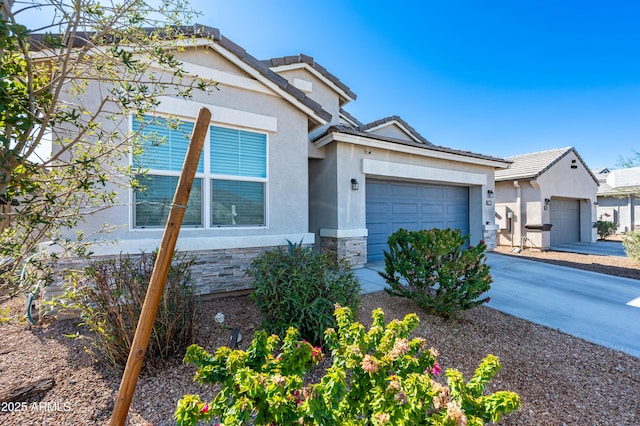 view of front facade featuring stone siding, stucco siding, concrete driveway, and a garage