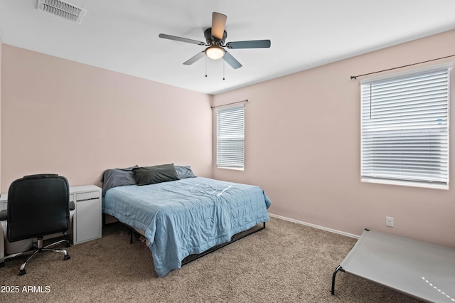 bedroom with a ceiling fan, carpet flooring, baseboards, and visible vents