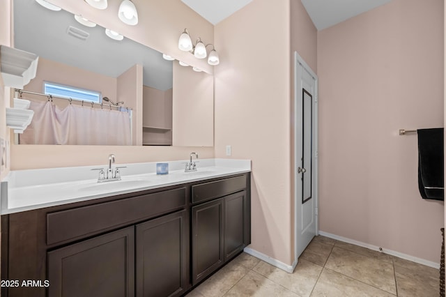 full bath with tile patterned floors, visible vents, double vanity, and a sink