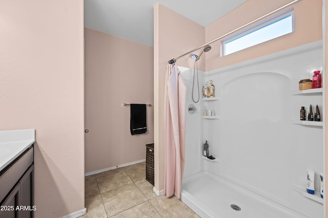 bathroom featuring vanity, curtained shower, baseboards, and tile patterned flooring