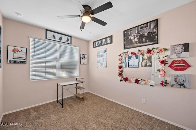 interior space with baseboards, carpet, and ceiling fan