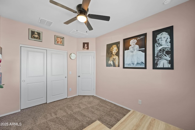 unfurnished bedroom with baseboards, visible vents, a closet, and ceiling fan