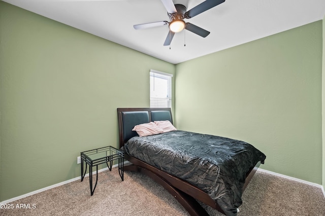 carpeted bedroom with ceiling fan and baseboards