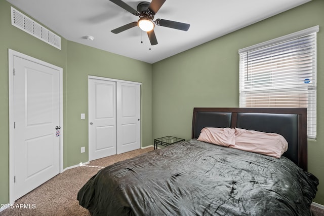 bedroom featuring visible vents, baseboards, carpet flooring, a closet, and a ceiling fan