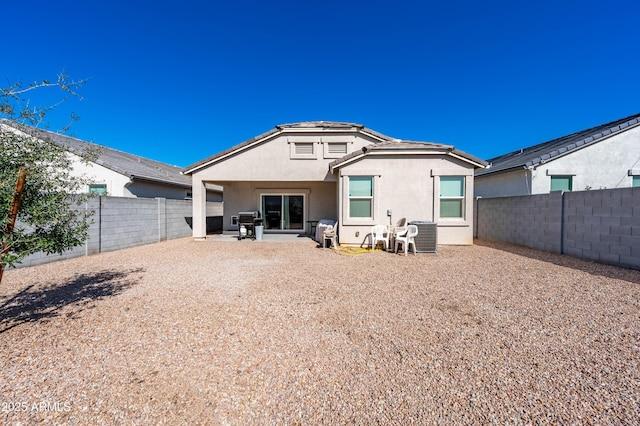 back of property featuring stucco siding, a patio, and a fenced backyard