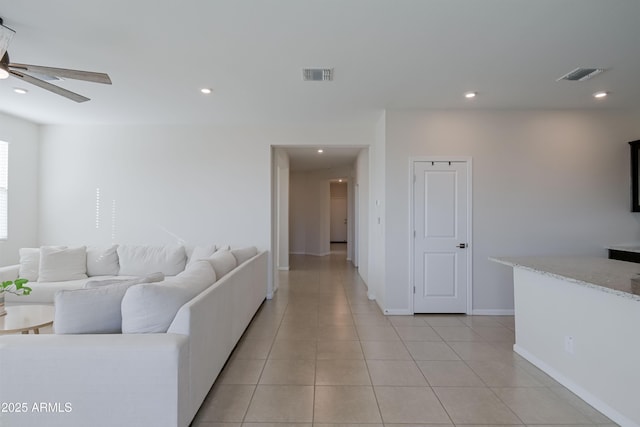 living room featuring light tile patterned floors, visible vents, and recessed lighting