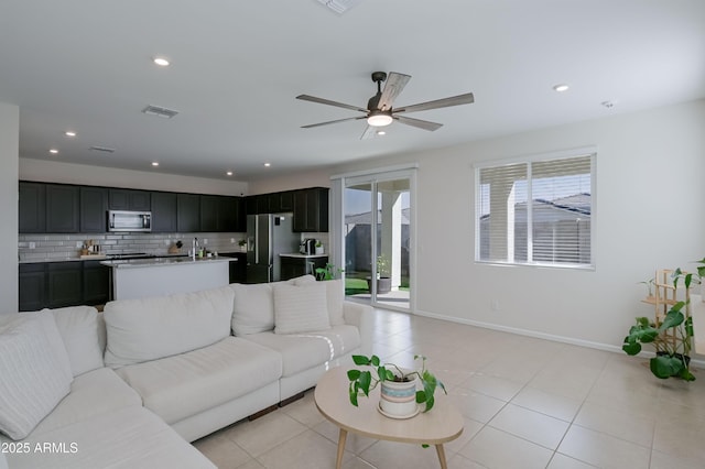 living room with baseboards, light tile patterned flooring, visible vents, and recessed lighting