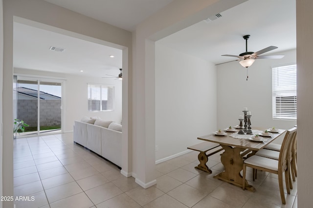 dining room featuring a ceiling fan, visible vents, baseboards, and light tile patterned floors