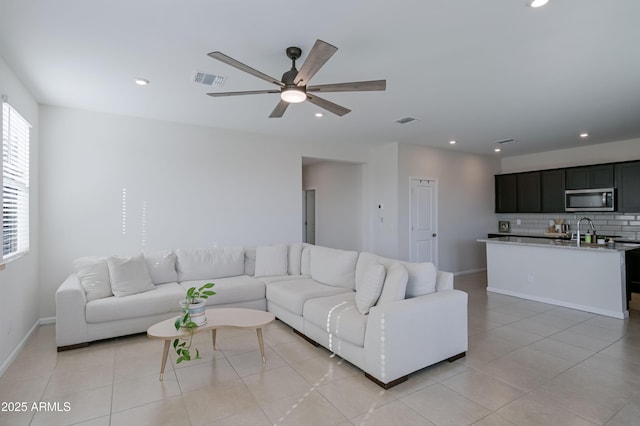 living room with light tile patterned floors, a ceiling fan, visible vents, and recessed lighting