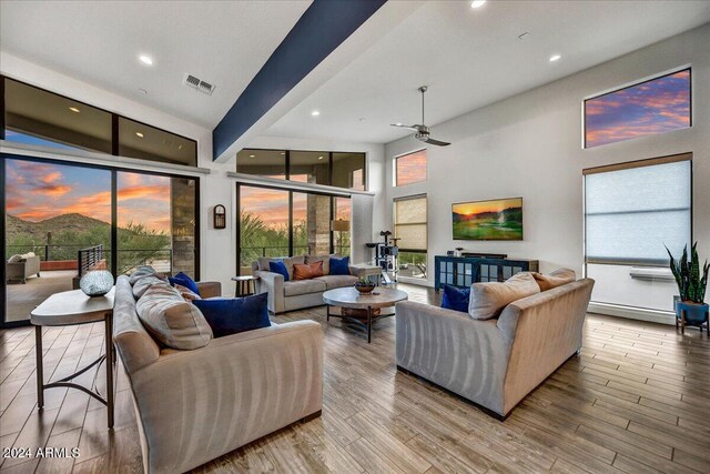 dining room featuring light hardwood / wood-style floors and high vaulted ceiling