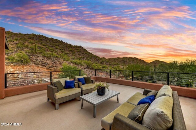 view of patio / terrace with a mountain view, a balcony, and an outdoor living space