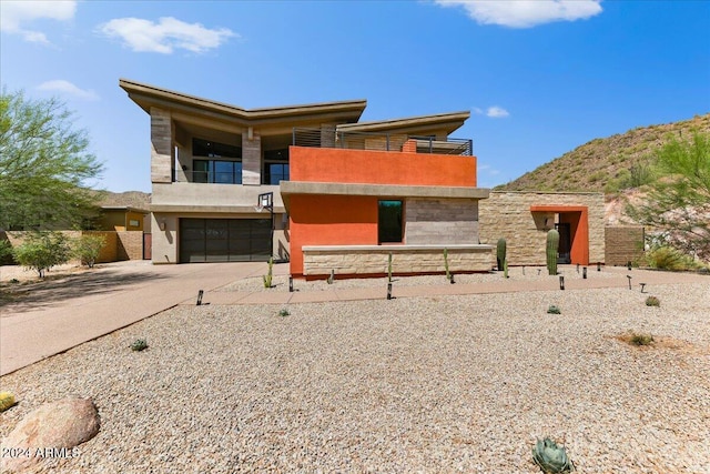 modern home featuring a balcony and a garage