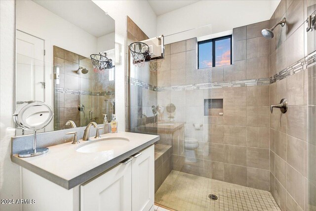 bathroom with vanity, an enclosed shower, and toilet