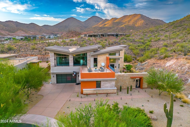 exterior space featuring a garage and a mountain view