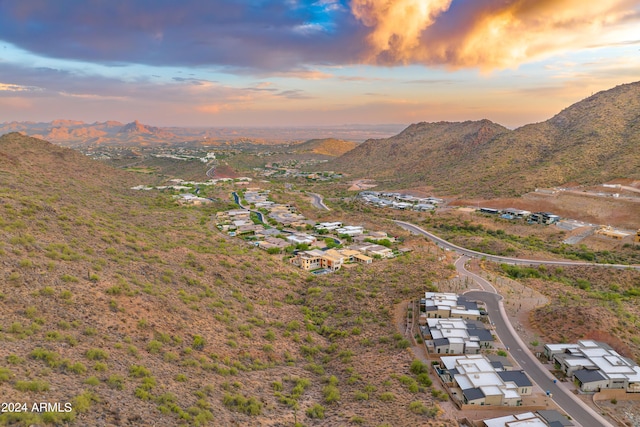 aerial view at dusk featuring a mountain view