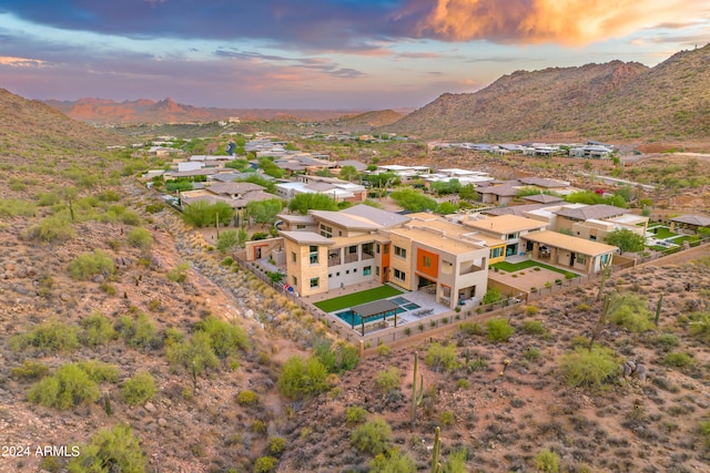 aerial view at dusk featuring a mountain view