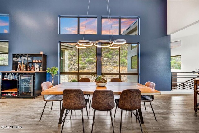 living room featuring ceiling fan, high vaulted ceiling, and light wood-type flooring