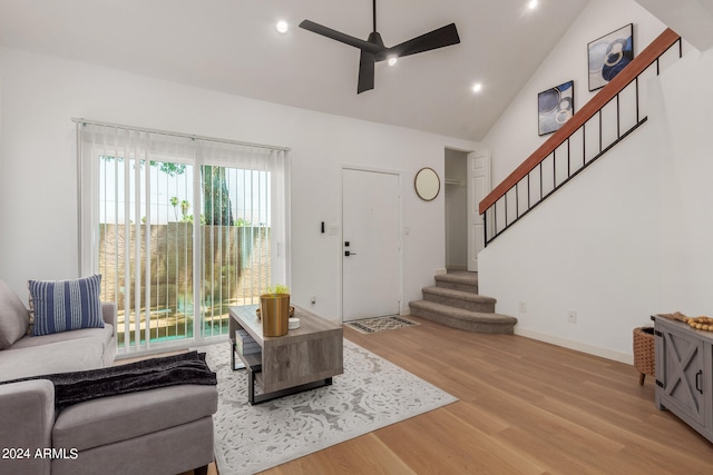 living room featuring high vaulted ceiling, light hardwood / wood-style floors, and ceiling fan