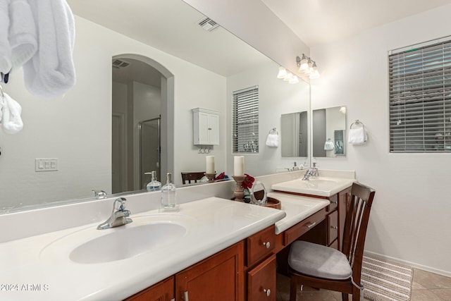 bathroom with vanity, a shower with shower door, and tile patterned flooring