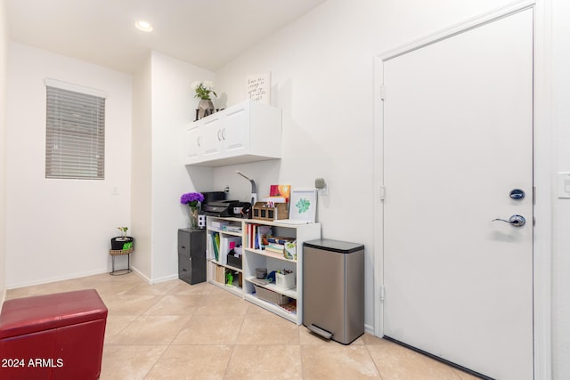 interior space featuring white cabinets and light tile patterned flooring