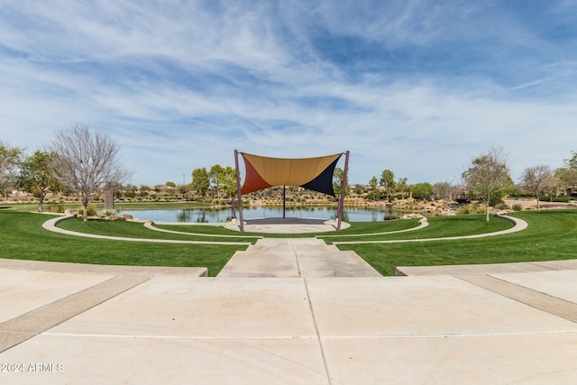 view of property's community featuring a water view and a lawn