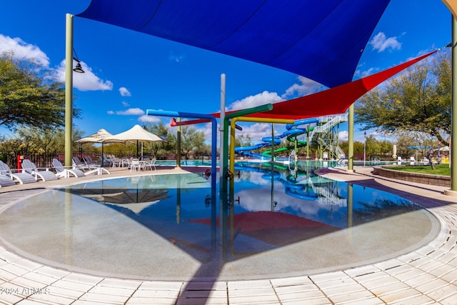 view of swimming pool with a playground