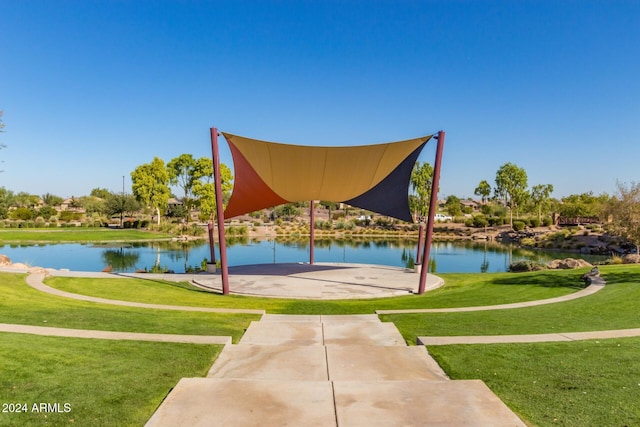 view of property's community featuring a water view and a lawn