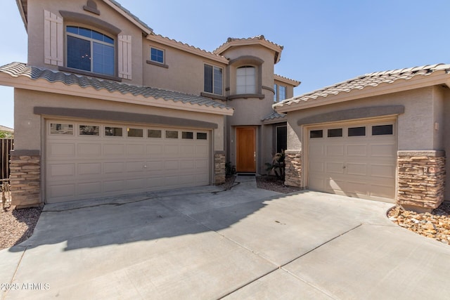 mediterranean / spanish-style house with stone siding, driveway, and stucco siding