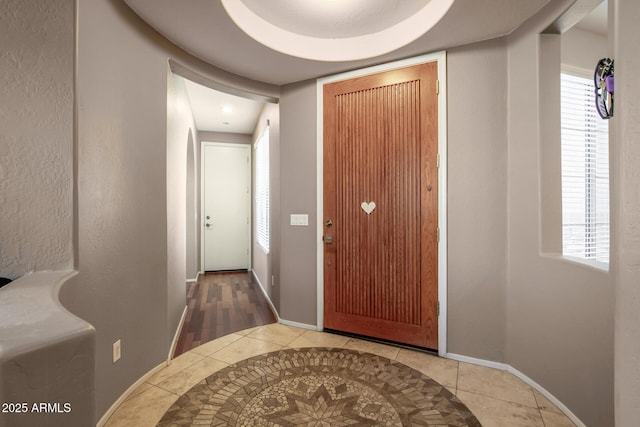 interior space with tile patterned flooring and baseboards