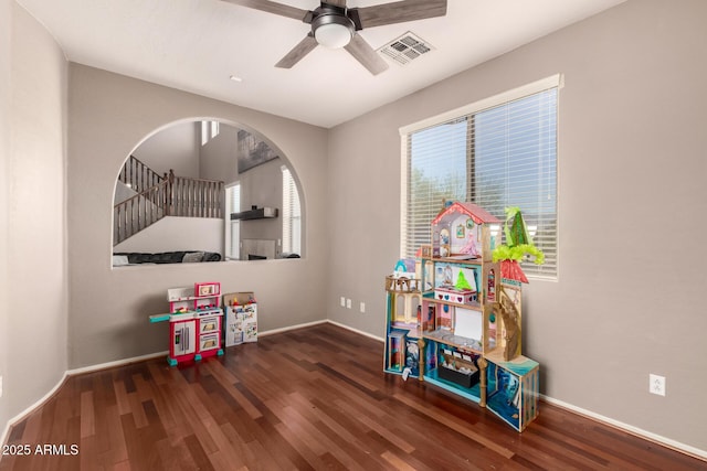 rec room with visible vents, wood finished floors, baseboards, and ceiling fan